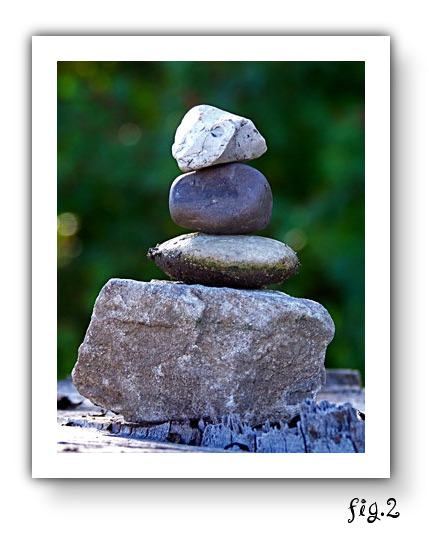 (photo: a rock cairn, a deliberate pile of rocks)